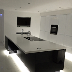 modern kitchen with white counter and black gloss finish